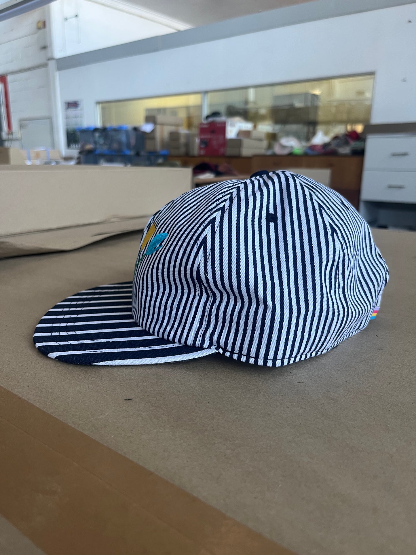 Cap with pin stripe embroidered tulip flower in ABC colours